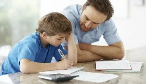 Young man assisting his little son with some home work